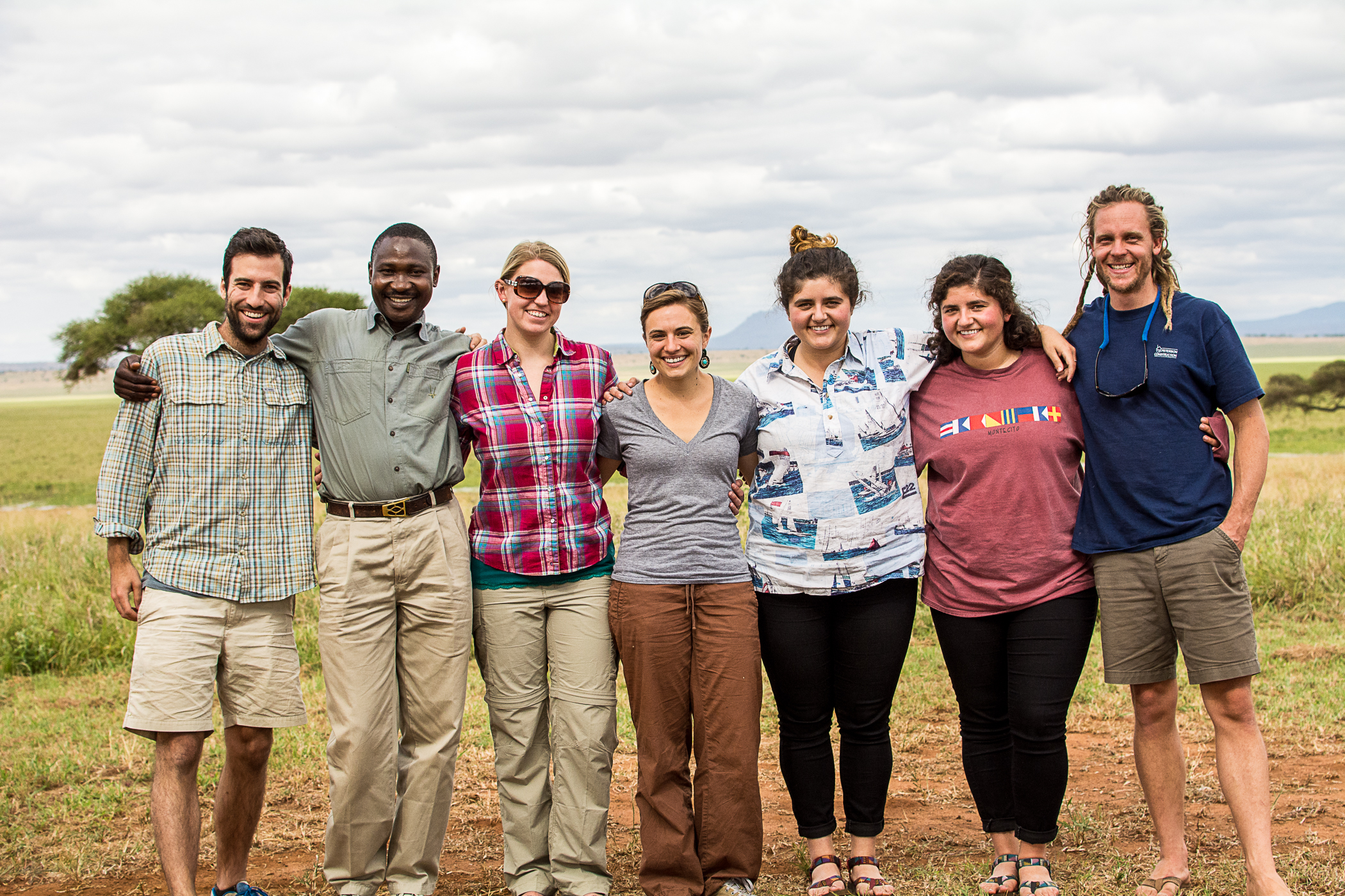 Travelers smiling together on the savanna in Tanzania